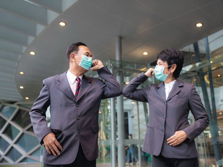 Old_asian_business_people_greeting_togather_by_new_methode_with_mask_for_prevent_covid_19,_this_image_can_use_for_covid-19,_corona_virus_and_shakehands_concept.