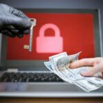 Computer_security_and_hacking_concept._Ransomware_virus_has_encrypted_data_in_laptop._Hacker_is_offering_key_to_unlock_encrypted_data_for_money.