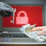 Computer_security_and_hacking_concept._Ransomware_virus_has_encrypted_data_in_laptop._Hacker_is_offering_key_to_unlock_encrypted_data_for_money.