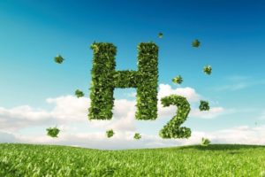 Eco_friendly_clean_hydrogen_energy_concept._3d_rendering_of_hydrogen_icon_on_fresh_spring_meadow_with_blue_sky_in_background.