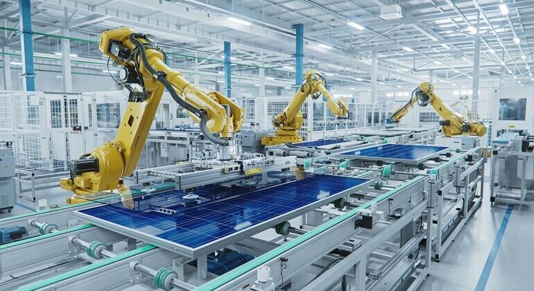 Large_Production_Line_with_Industrial_Robot_Arms_at_Modern_Bright_Factory._Solar_Panels_are_being_Assembled_on_Conveyor._Automated_Manufacturing_Facility