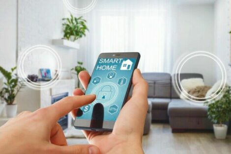 Smart_home_technology_interface_on_smartphone_app_screen_with_augmented_reality_(AR)_view_of_internet_of_things_(IOT)_connected_objects_in_the_apartment_interior,_person_holding_device