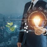 businessman_holding_light_bulb_against_nature_on_city_background__with_icons_energy_sources_for_renewable,_sustainable_development,__Ecology_and_renewable_energy_concept.