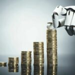 Close-up_Of_A_Robot's_Hand_Stacking_Golden_Coins_On_Grey_Background