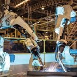 Team_industrial_robot_are_welding_in_automotive_industrial_factory