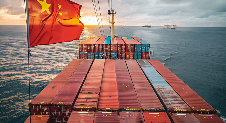 A_large_cargo_ship_with_a_Chinese_flag_flies_proudly_in_the_wind_as_it_sails_through_the_ocean._The_ship_is_loaded_with_rows_of_containers,_signifying_global_trade_and_transport.