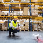 Man_or_a_worker_with_drone_in_a_warehouse.