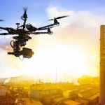 Professional_drone_flying_over_factory_at_sunset