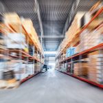 Warehouse_industrial_and_logistics_companies._Long_shelves_with_a_variety_of_boxes_and_containers._Motion_blur_effect.