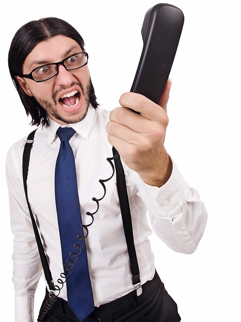 Angry_businessman_with_phone_isolated_on_white