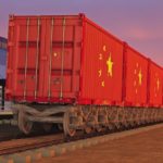 train_with_containers_with_the_flag_of_China_driving_near_the_buildings_of_the_logistics_center