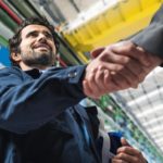 Portrait_of_a_man_giving_an_handshake_in_an_industrial_facility