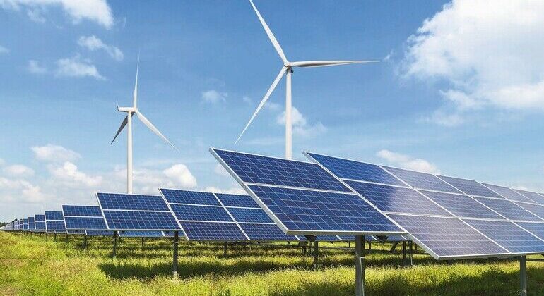 solar_panels_and_wind_turbines_generating_electricity_in_power_station_green_energy_renewable_with_blue_sky_background