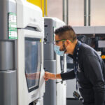 General_Motors_Additive_Manufacturing_Engineer_Pedro_Ledezma_working_with_3D_printers_in_the_General_Motors_Additive_Industrialization_Center_at_the_GM_Tech_Center_in_Warren,_Michigan._(Photo_by_Steve_Fecht_for_General_Motors)