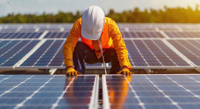 A_worker_inspecting_eco-friendly_solar_panels_under_sunlight,_promoting_renewable_energy_and_sustainable_practices.