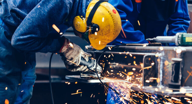 Worker_grinding_in_a_workshop._Heavy_industry_factory,_metalwork
