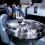 A_modern_CNC_milling_machine_makes_a_large_cogwheel._Accurate_metal_working._Shooting_in_real_conditions,_maybe_some_blurring_and_grain.